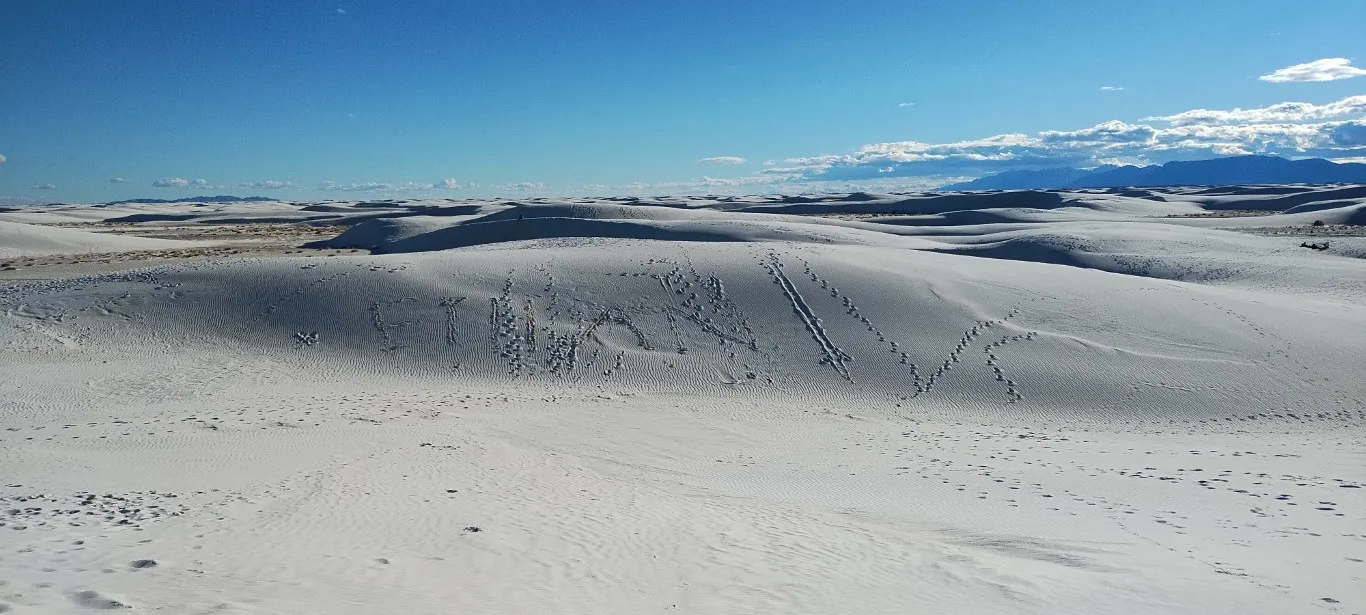 A large white sand dune with the word ‘ETHAN’ scrawled on it